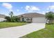 House exterior featuring a driveway and landscaping at 4145 Polynesia Rd, North Port, FL 34288