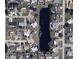 Aerial view showcases neighborhood layout with a central pond, surrounding homes, and the street grid at 42 Caroll Cir, Englewood, FL 34223