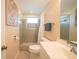 Clean bathroom with a shower/tub combo and tiled walls at 42 Caroll Cir, Englewood, FL 34223