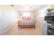 Bright bedroom with tiled floors, double closet, and a workspace at 42 Caroll Cir, Englewood, FL 34223