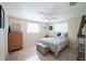 Cozy bedroom with tile floors, ceiling fan and natural light from a bright window at 42 Caroll Cir, Englewood, FL 34223