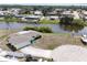 Waterfront home with a boat and canal access in a quiet neighborhood with palm trees at 42 Caroll Cir, Englewood, FL 34223
