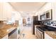 Modern kitchen with stainless steel appliances and granite counters at 42 Caroll Cir, Englewood, FL 34223