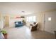 Open-concept living room with modern furnishings, ceramic floors, and a large window providing abundant natural light at 42 Caroll Cir, Englewood, FL 34223