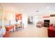 Bright living room with tiled floors, red sofa and eclectic decor at 42 Caroll Cir, Englewood, FL 34223
