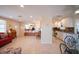 Open-concept living space featuring tile floors, a cozy seating area, and a view into the kitchen at 42 Caroll Cir, Englewood, FL 34223