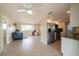 Bright and airy living space featuring an open layout, stainless appliances, tile flooring, and ample natural light at 42 Caroll Cir, Englewood, FL 34223