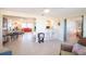Spacious open-concept living space showcasing tile flooring, a kitchen bar, and a seamless flow between rooms at 42 Caroll Cir, Englewood, FL 34223