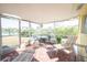 Relaxing screened patio with comfortable lounge chairs and pond views, ideal for enjoying the outdoors at 42 Caroll Cir, Englewood, FL 34223