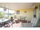 Relaxing screened porch with lake views and patio furniture at 42 Caroll Cir, Englewood, FL 34223