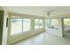 Light-filled sunroom with canal view, neutral flooring, and multiple windows perfect for relaxing and enjoying the scenery at 42 Caroll Cir, Englewood, FL 34223