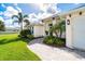 One-story home with a two-car garage, walkway and tropical landscaping at 592 Boundary Blvd, Rotonda West, FL 33947