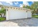 Two-car garage with white doors and paver driveway at 592 Boundary Blvd, Rotonda West, FL 33947