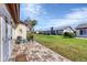 Cozy patio with brick pavers, two chairs, and access to backyard at 618 Deerwood Ave, Englewood, FL 34223