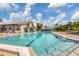 Large community pool with plenty of lounge chairs at 618 Deerwood Ave, Englewood, FL 34223