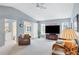 Open living area with vaulted ceilings, wicker furniture, and access to lanai at 618 Deerwood Ave, Englewood, FL 34223