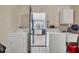 Laundry room with washer, dryer, sink, and access to kitchen at 618 Deerwood Ave, Englewood, FL 34223