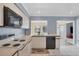 Clean kitchen with black appliances and a view into the living area at 618 Deerwood Ave, Englewood, FL 34223
