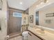 Clean bathroom with shower/tub combo, tile surround, and vanity at 618 Deerwood Ave, Englewood, FL 34223