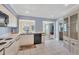 Bright kitchen features white cabinetry, black appliances, and tile flooring at 618 Deerwood Ave, Englewood, FL 34223