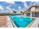 Community pool with lounge chairs and pool house at 618 Deerwood Ave, Englewood, FL 34223