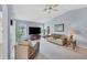 Bright living room featuring vaulted ceilings, comfortable seating, and a large TV at 618 Deerwood Ave, Englewood, FL 34223