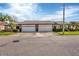 Two-unit villa building showcasing attached garages and well-maintained lawns at 618 Deerwood Ave, Englewood, FL 34223