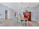 Charming dining room with oval table, chairs, and wooden cabinet at 618 Deerwood Ave, Englewood, FL 34223