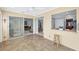 Sunroom boasts tile flooring, sliding glass doors, and a view of the living room at 618 Deerwood Ave, Englewood, FL 34223