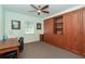 Bedroom with built-in wooden cabinets and workspace at 7212 Teaberry St, Englewood, FL 34224