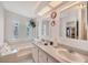 Bathroom boasts dual sinks, an updated countertop and a large bathtub at 749 Riverview Cir, North Port, FL 34287