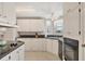 White cabinets, granite countertops, and a built-in oven are featured in this kitchen at 749 Riverview Cir, North Port, FL 34287