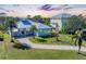 Aerial view of a charming waterfront home with a large yard at 8025 Weyers Ct, Englewood, FL 34224