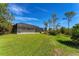 Spacious backyard with lush lawn and tropical landscaping at 8025 Weyers Ct, Englewood, FL 34224