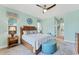 Main bedroom with king-size bed, wood furniture and light teal walls at 8025 Weyers Ct, Englewood, FL 34224