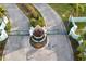 Gated community entrance with lush landscaping and a decorative fountain at 8025 Weyers Ct, Englewood, FL 34224