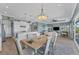 Bright dining room with light wood table and chairs, adjacent to kitchen at 8025 Weyers Ct, Englewood, FL 34224