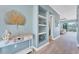 Inviting entryway with built-in shelving and a view to living area at 8025 Weyers Ct, Englewood, FL 34224