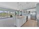 Spacious kitchen with white cabinets, granite countertops, and stainless steel appliances at 8025 Weyers Ct, Englewood, FL 34224