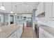 Modern kitchen with white cabinets, granite countertops, and stainless steel appliances at 8025 Weyers Ct, Englewood, FL 34224