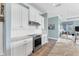Modern kitchen with white cabinets, granite countertops, and stainless steel appliances at 8025 Weyers Ct, Englewood, FL 34224