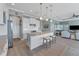 Open concept kitchen with island, stainless steel appliances, and white shaker cabinets at 8025 Weyers Ct, Englewood, FL 34224