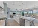 Open kitchen features a large island, white cabinetry, and views into the living area at 8025 Weyers Ct, Englewood, FL 34224