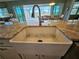 Farmhouse sink with a modern gooseneck faucet in the kitchen at 8025 Weyers Ct, Englewood, FL 34224
