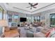 Spacious living room with ample seating and access to screened porch at 8025 Weyers Ct, Englewood, FL 34224