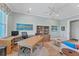 Home office with wood desk, built-in shelving, and comfortable seating at 8025 Weyers Ct, Englewood, FL 34224