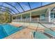 Inviting pool area with screened enclosure, patio, and view of the home at 8025 Weyers Ct, Englewood, FL 34224