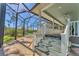 Steps leading down to a screened pool and patio area at 8025 Weyers Ct, Englewood, FL 34224