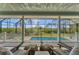 Screened pool deck with comfortable seating overlooking the pool and preserve at 8025 Weyers Ct, Englewood, FL 34224