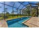 Enjoy this refreshing screened pool with a spa and a tranquil view at 8025 Weyers Ct, Englewood, FL 34224